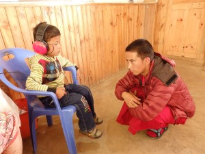 Dorje & young child doing a hearing test